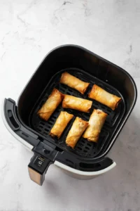 Preheat your air fryer and cook egg rolls