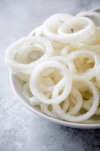 Prep the onion by slicing it into thick rings
