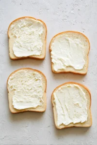 Spread butter on one side of each slice of bread