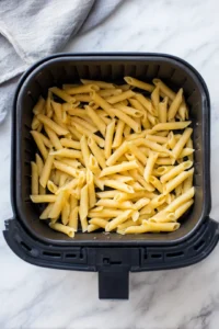 Spread pasta in air fryer until crispy and golden brown