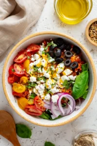 Spread the mixture onto the prepared baking sheet and top with cherry tomatoes, bell peppers, mozzarella cheese, and Italian seasoning. Bake for 15 minutes or until golden and bubbly.