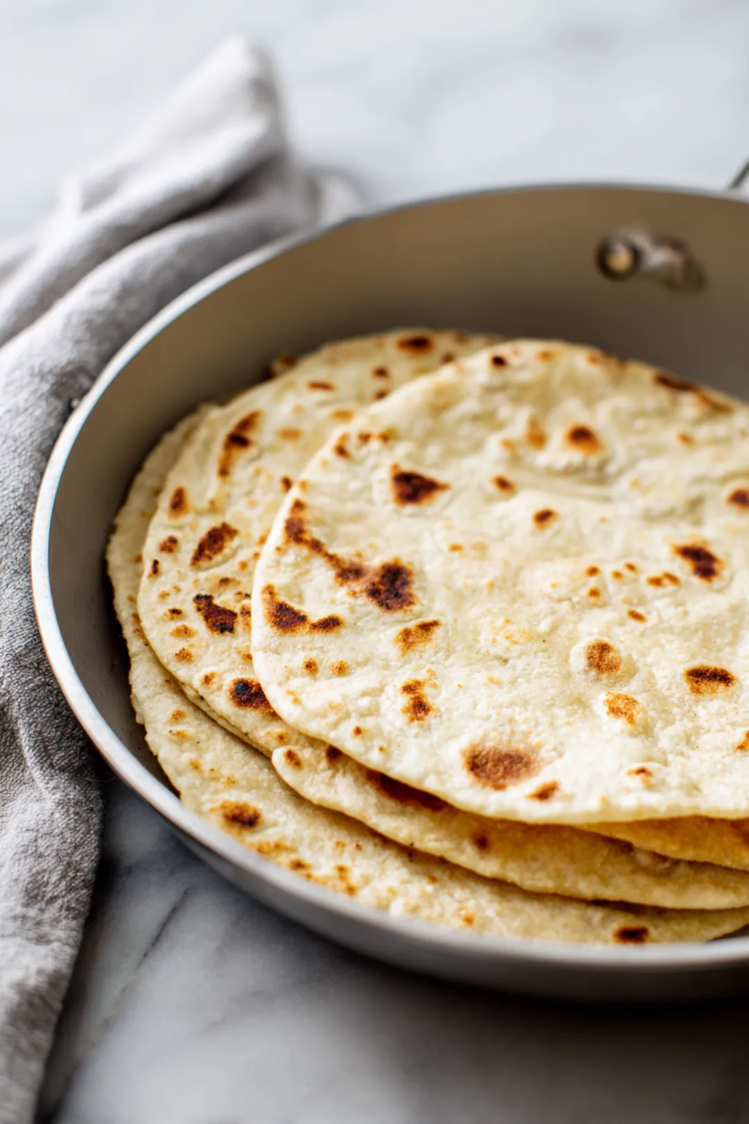 Warm the corn tortillas until pliable
