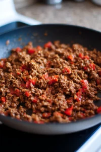 Warm the leftover taco meat in a skillet on medium heat