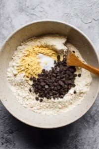 Add flour, baking soda, salt, and vanilla extract to the mixture and stir to combine. Fold in chocolate chips.