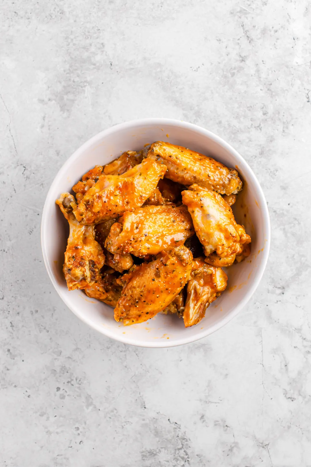 Add the chicken wings to the marinade and toss to coat evenly. Let them marinate for at least 30 minutes.