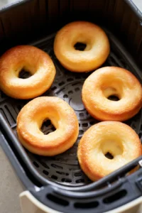 Air fry the donuts in batches until golden brown