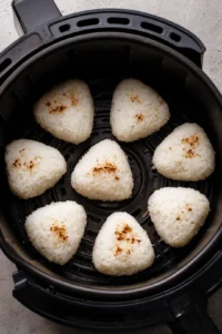 Arrange onigiri in air fryer and cook until golden brown
