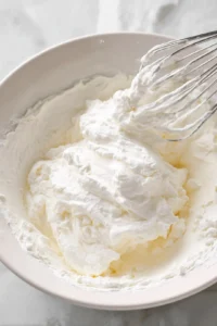 Beat the cream cheese, sugar, and vanilla, then fold in the whipped cream