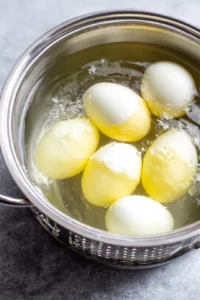 Boil eggs until hard boiled and peel them