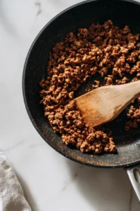 Brown ground beef in a skillet and season with taco seasoning
