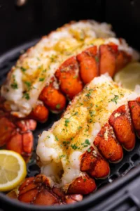 Brush lobster meat with melted butter and garlic powder, then air fry for 10-15 minutes