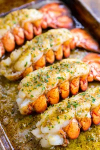 Brush lobster tails with garlic lemon butter and bake until cooked