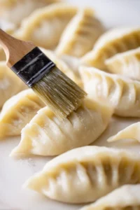 Brush the frozen dumplings lightly with oil