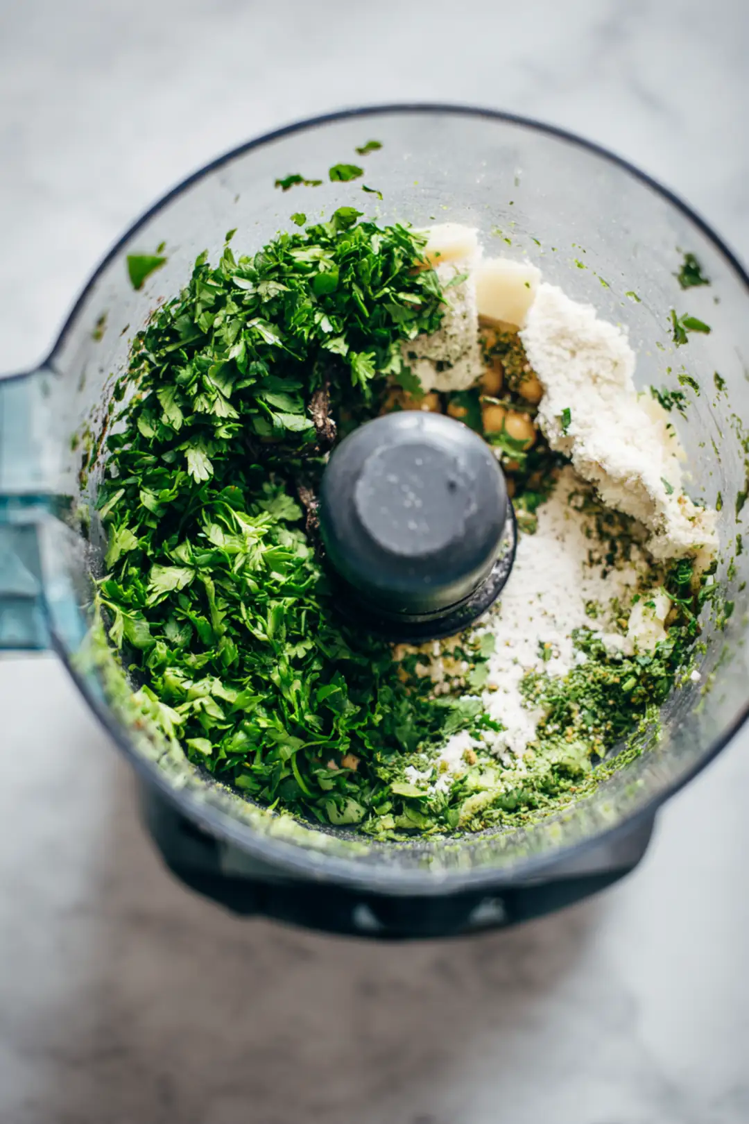 Combine chickpeas, parsley, onion, garlic, cumin, coriander, salt, black pepper, and flour in a food processor, then pulse until coarsely blended