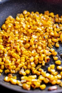 Combine fresh corn kernels, Greek yogurt, lime juice, chili powder, and salt in a large bowl