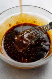 Combine gochujang, soy sauce, and maple syrup in a mixing bowl and stir until blended