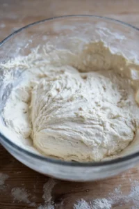 Combine Greek yogurt and self-rising flour to form a sticky dough