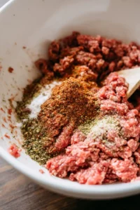 Combine ground beef with spices and form into patties