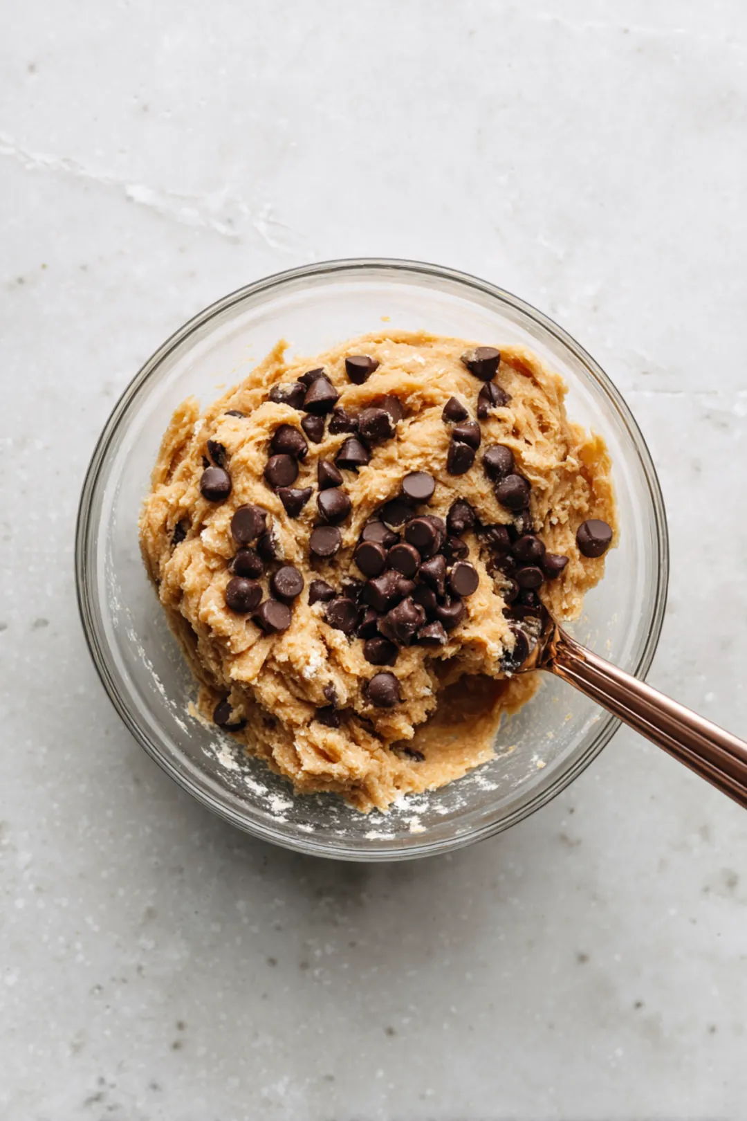 Combine mashed ripe bananas and flour in a mixing bowl until a dough forms, then fold in chocolate chips if desired