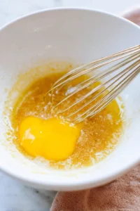 Combine melted butter, brown sugar, and egg yolk in a mixing bowl and whisk until smooth