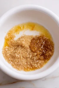 Combine melted butter, brown sugar, and granulated sugar in a mixing bowl
