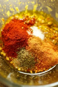 Combine olive oil, smoked paprika, garlic powder, salt, pepper, and chili powder in a bowl