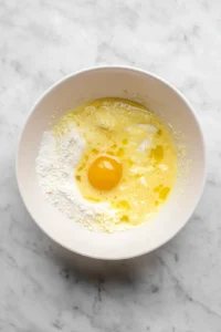 Combine pancake mix, sugar, milk, egg, vanilla, and melted butter in a mixing bowl