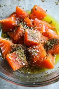 Combine salmon pieces with olive oil and seasoning