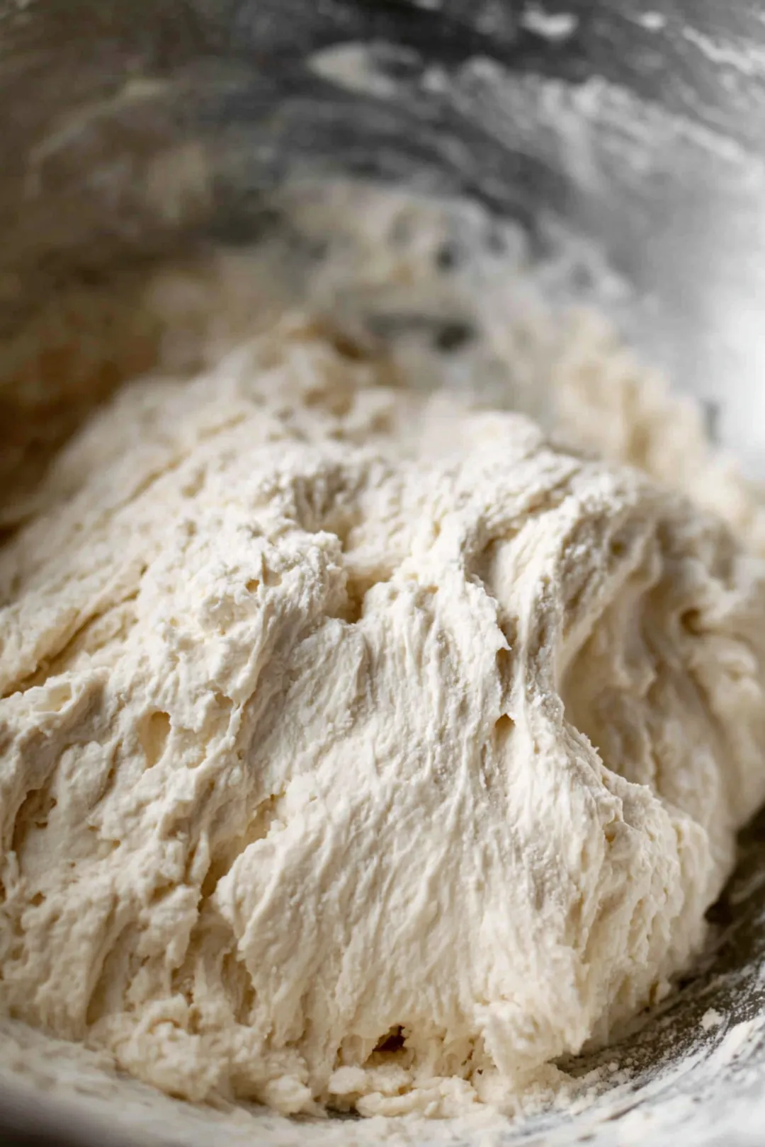 Combine self-rising flour and Greek yogurt in a mixing bowl to create a shaggy dough