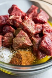 Combine steak bites with olive oil, garlic powder, smoked paprika, salt, and black pepper in a bowl