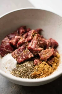 Combine steak tips with seasonings in a large bowl