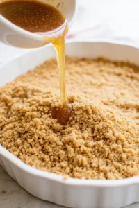 Combine the crushed graham crackers and melted butter to form the crust