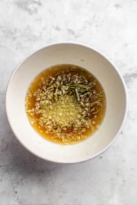 Combine the lukewarm water, chopped lemongrass, grated ginger, soy sauce, and honey in a mixing bowl