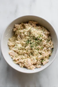 Combine tuna with egg and breadcrumbs in a bowl