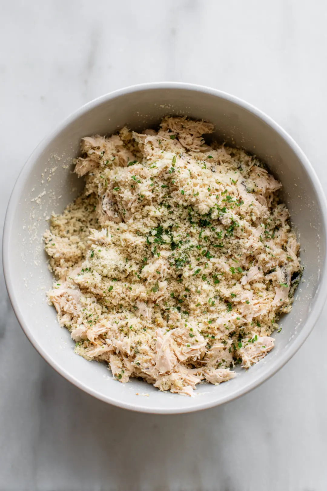 Combine tuna with egg and breadcrumbs in a bowl