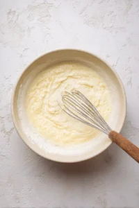 Combine warm water and yeast in a mixing bowl and let it sit for about 5 minutes until frothy