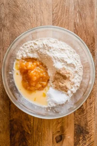 Combine whole wheat flour, baking powder, cinnamon, and salt, then mix applesauce, honey, and egg until blended.