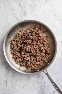 Cook ground beef in a skillet over medium heat until browned and drain excess fat.