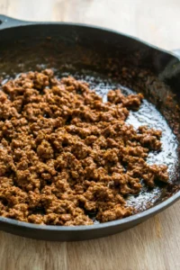 Cook ground beef in a skillet until browned