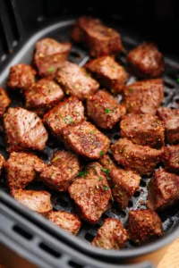 Cook the steak bites for 8 minutes, shaking the basket halfway through. Ensure the internal temperature reaches your desired level of doneness. Sprinkle with parsley before serving.