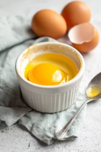 Crack the eggs into a lightly greased ramekin
