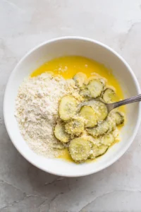 Dip pickle slices in egg wash and coat in dry mixture