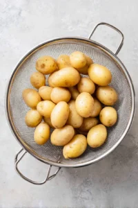 Drain the potatoes and let them cool for a few minutes