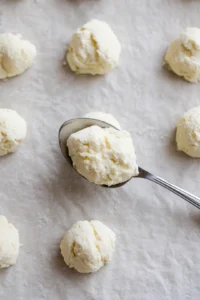 Drop biscuit dough onto a parchment-lined baking sheet