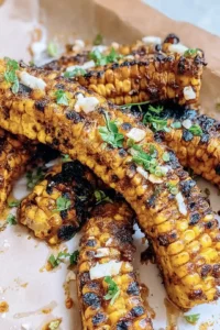 Grill or bake the corn ribs until they are tender and charred