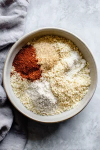 Mix almond flour, parmesan cheese, paprika, garlic powder, and onion powder to create the breading