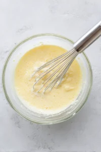 Mix flour, eggs, and milk in a bowl until smooth