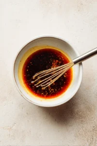 Mix soy sauce, honey, and sriracha to create the sauce