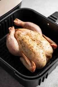 Place chicken in air fryer, cook for 30 minutes, flip and cook for another 30 minutes until done.