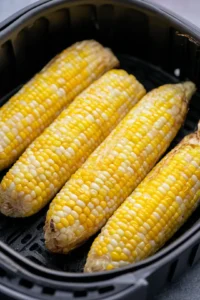Place corn in the air fryer basket and cook.